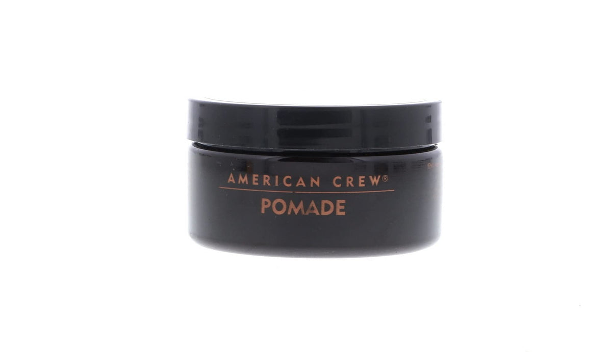 AMERICAN CREW pomade on hand being warmed for application showing easy spreadability benefit