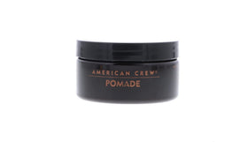 AMERICAN CREW pomade on hand being warmed for application showing easy spreadability benefit