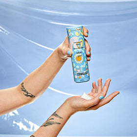 amika applied to hair section showing product spreading and immediate frizz control