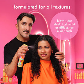 amika finished curled hair showcasing smooth, glossy frizz control