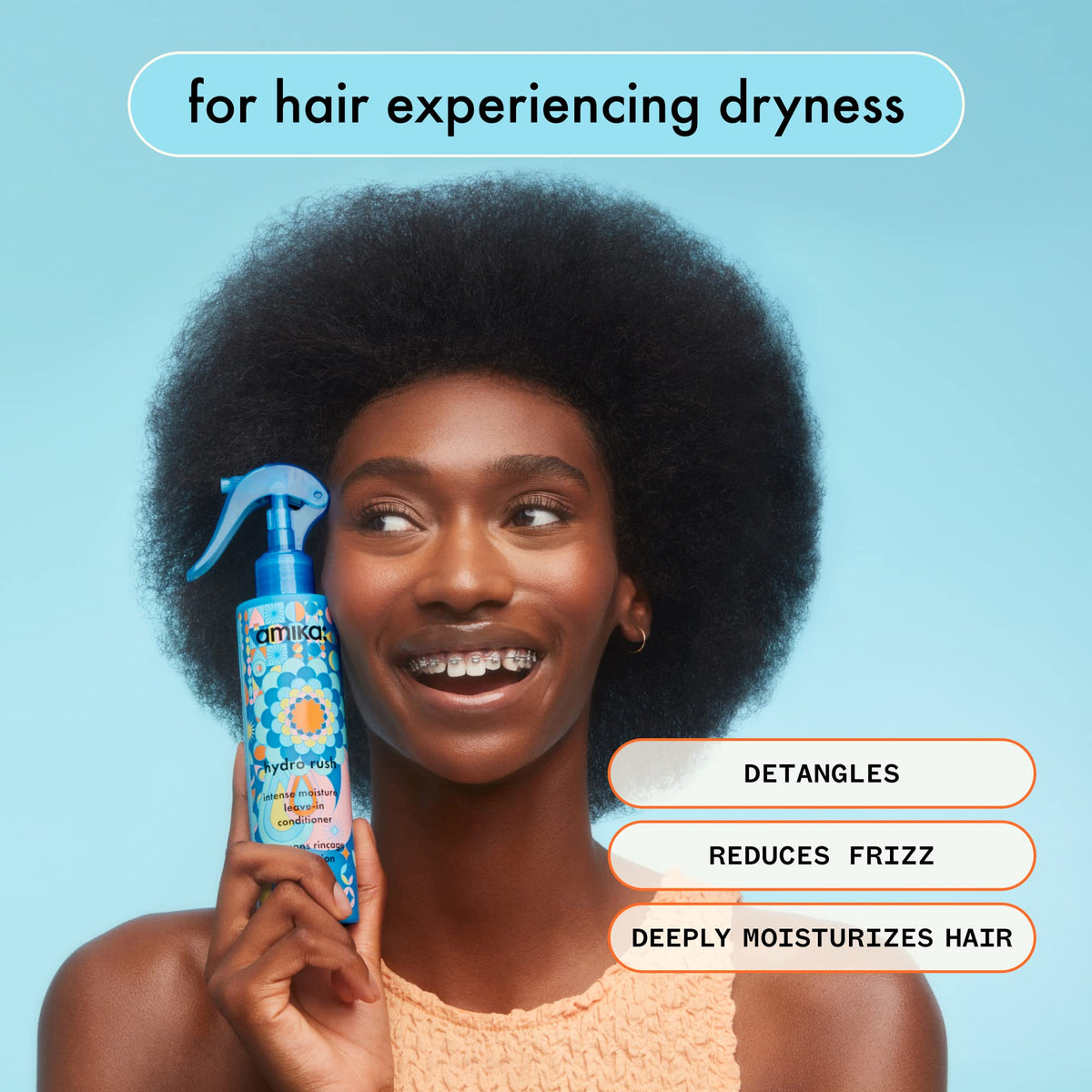 amika applying leave-in to damp hair for easier detangling benefit