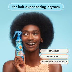 amika applying leave-in to damp hair for easier detangling benefit
