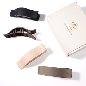 Amlaidu clips next to hand showing size comparison benefit: compact and portable