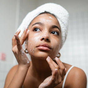 Ammoya Naturals turmeric powder next to bar illustrating brightening ingredient benefit