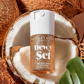 Anastasia Beverly Hills mist spraying on face to refresh makeup and hydrate