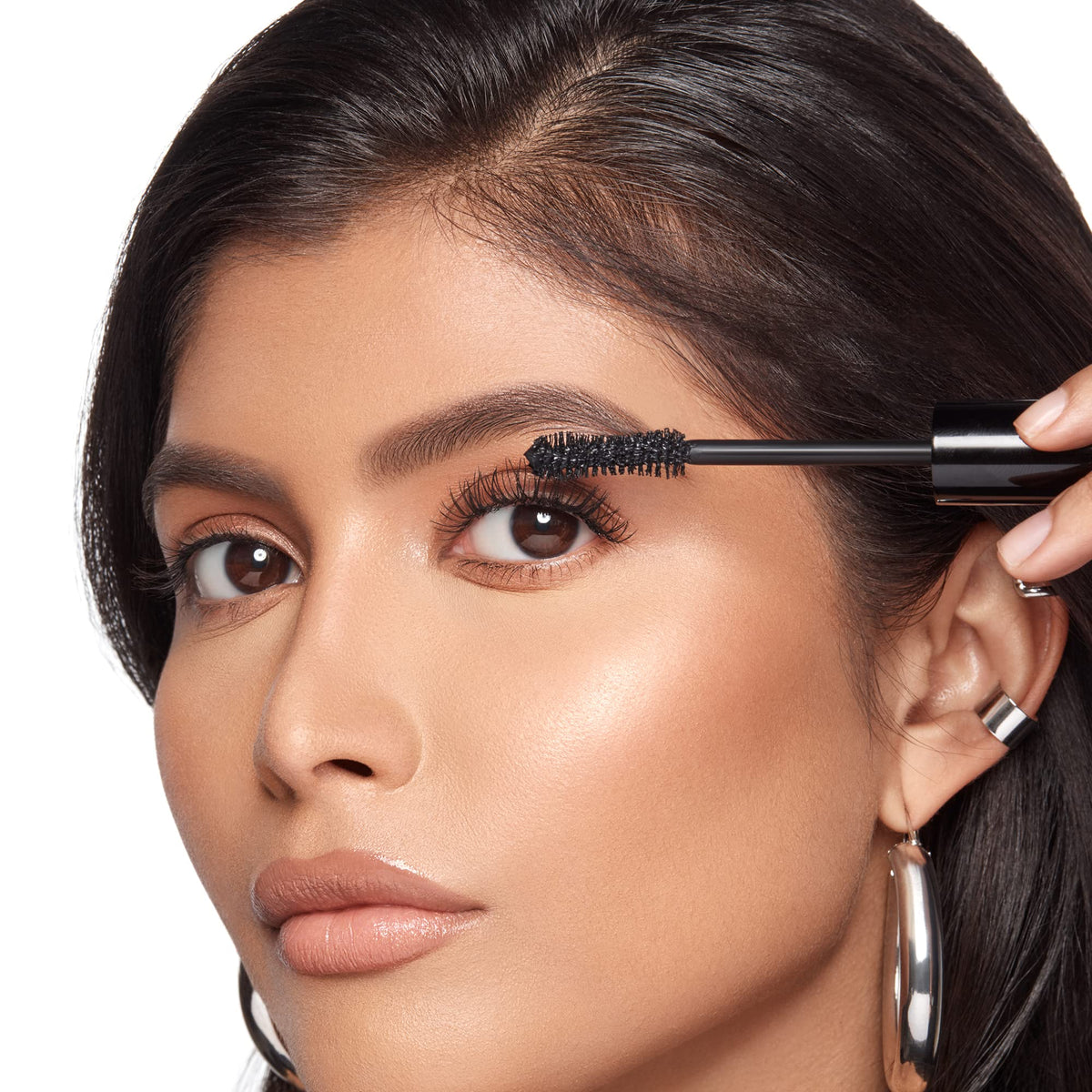 Anastasia Beverly Hills tube held in hand demonstrating compact travel-friendly size