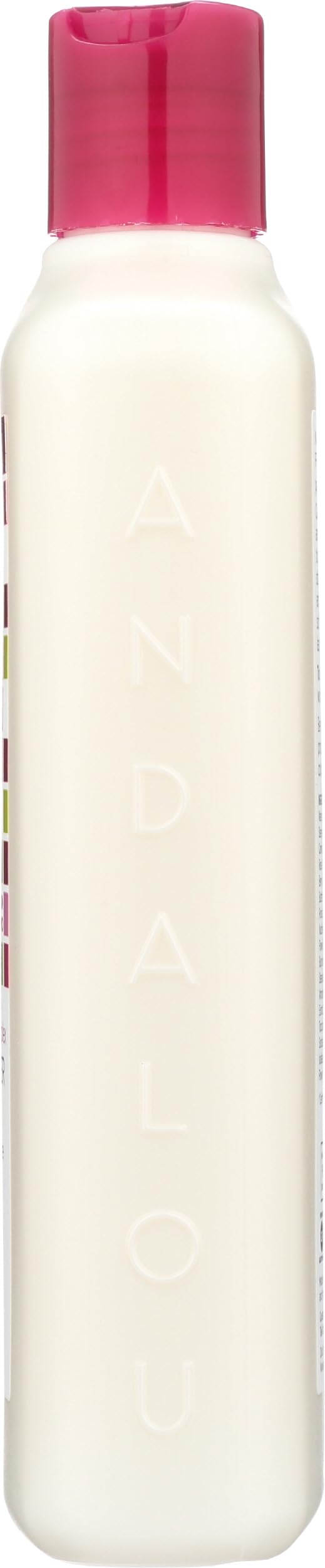 Andalou Naturals 11.5 ounce bottle held in hand for scale and size clarity