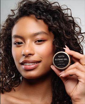 APRÉS technician applying Gel Novice under a Gel‑X tip for precise placement and reduced shifting