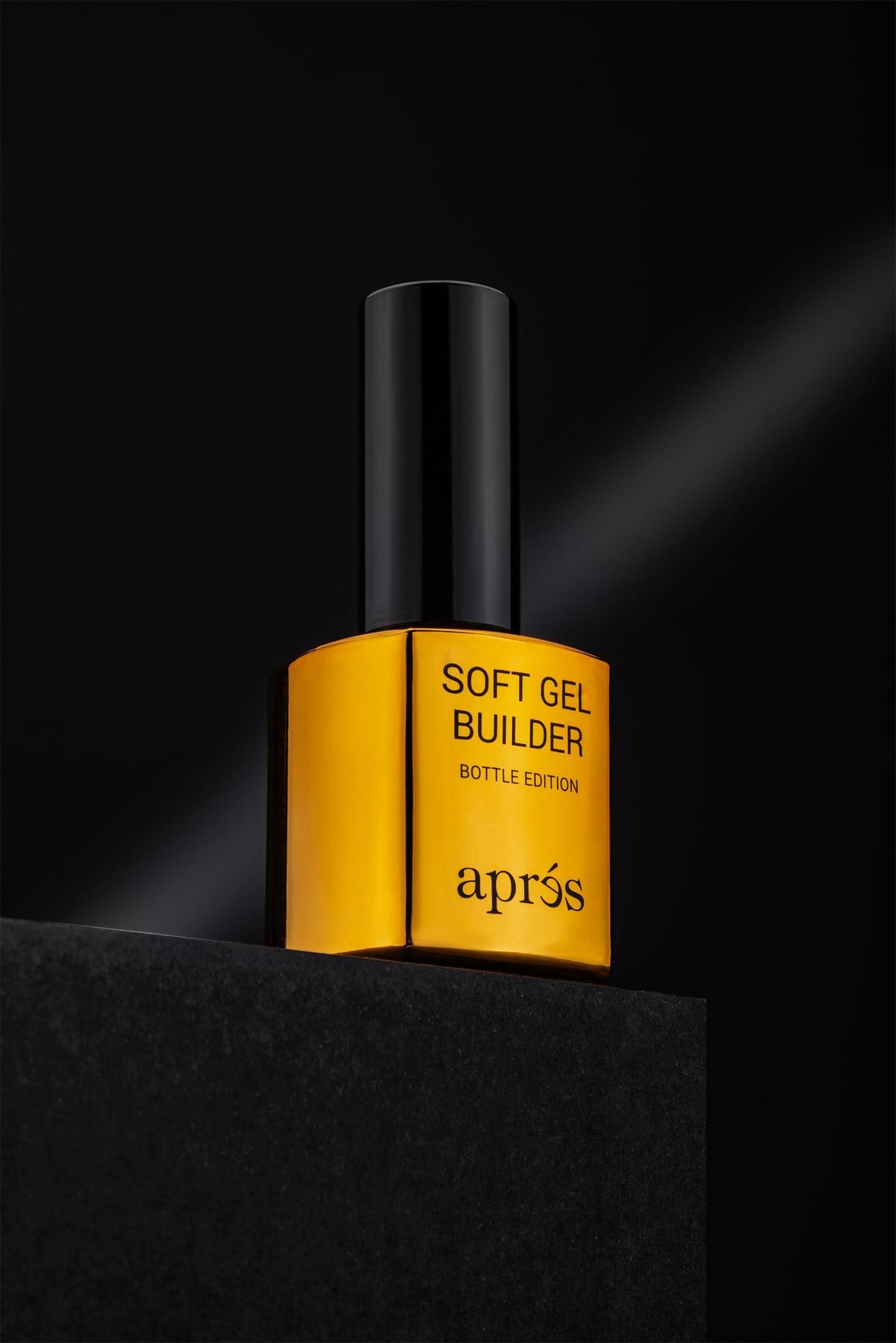 APRÉS bottle held in hand showing product size and professional use