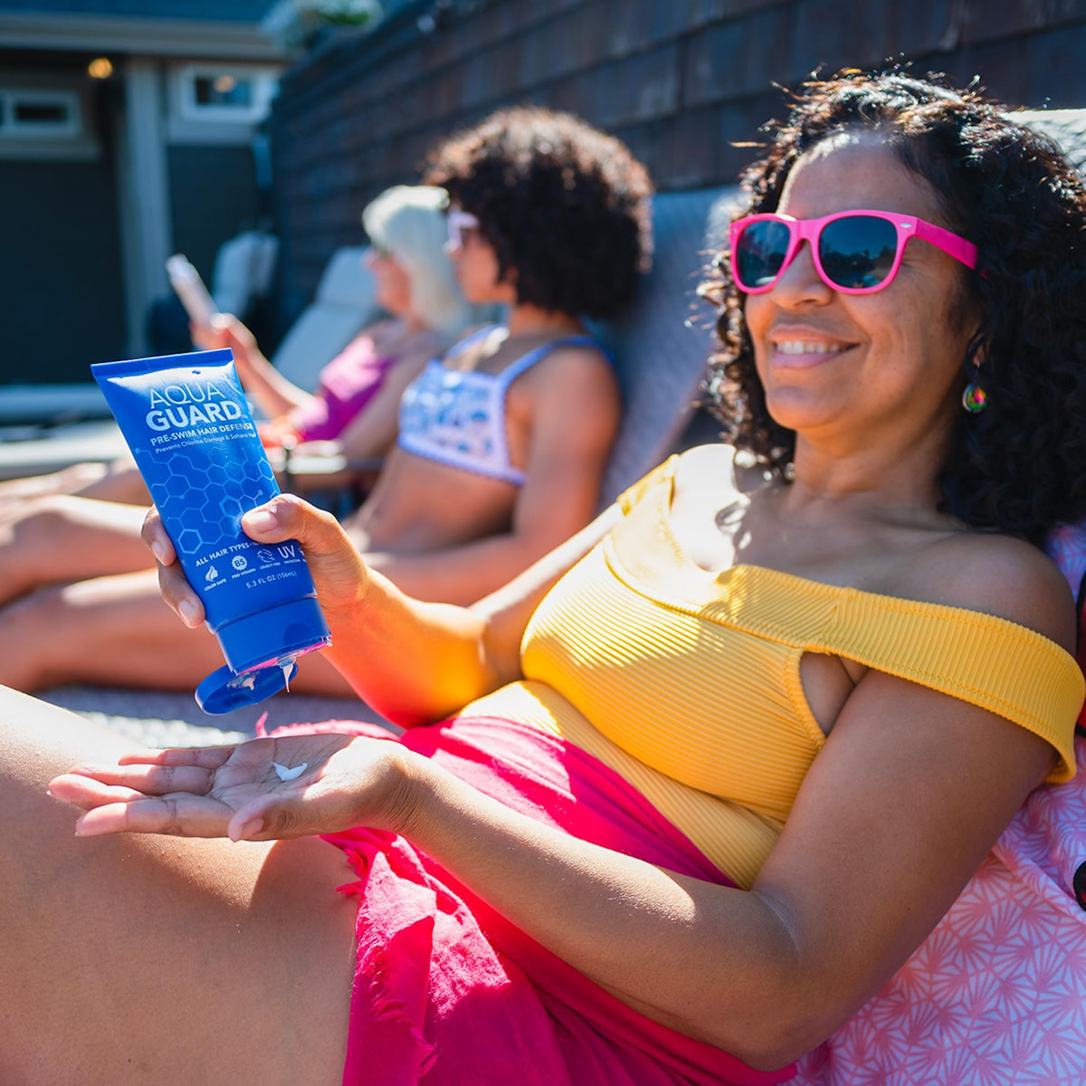AQUA GUARD being applied to damp hair showing protective coverage benefit