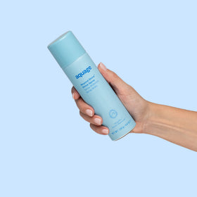 Aquage bottle beside common items showing travel-friendly 4.6 fl oz size