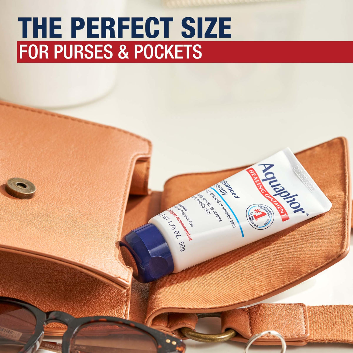 Aquaphor tube next to a credit card to illustrate compact travel size