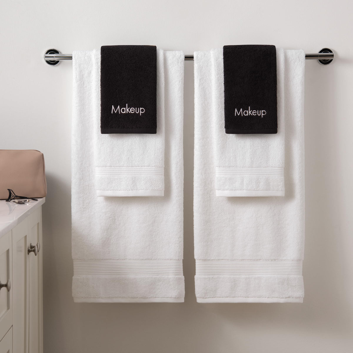 Arkwright folded stack on vanity presenting neat, dark-colored reusable face towels