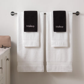Arkwright towels stacked by laundry basket indicating easy care and reuse