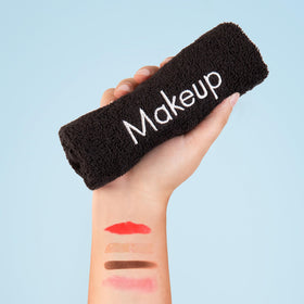 Arkwright towel beside a hand to show 13x13 inch scale for full-face coverage