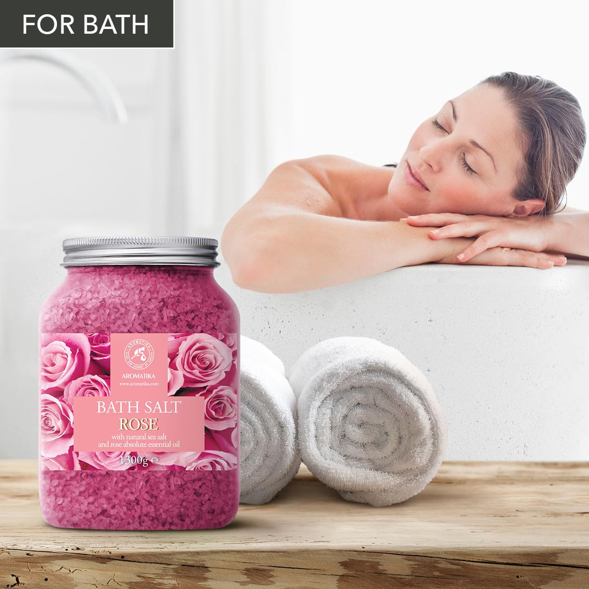 AROMATIKA pouring bath salts into running bathtub to create aromatic bath experience