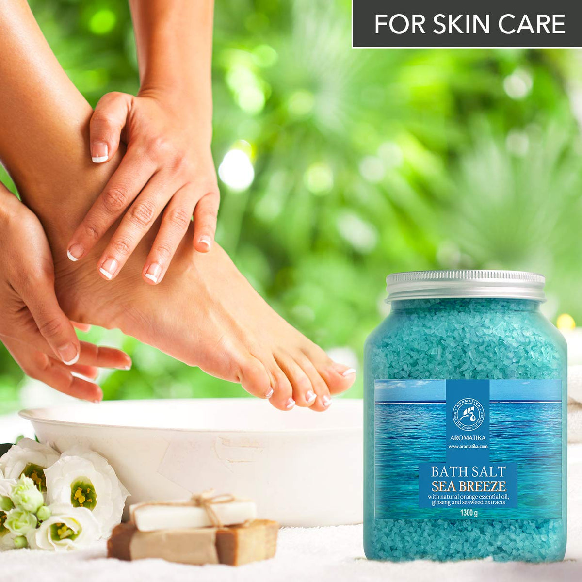 AROMATIKA foot soak bowl with salts and towel demonstrating home pedicure benefit