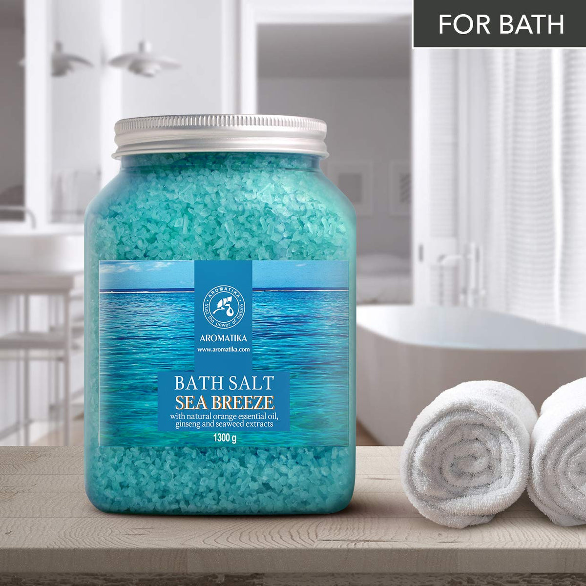 AROMATIKA sea salt dissolving in a bathtub creating relaxing aromatherapy soak
