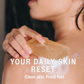 AROMAVITA soap on shower shelf in bathroom, suggests convenient everyday use