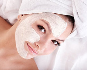 Aromine mask in use woman applying ghassoul paste demonstrating gentle cleansing