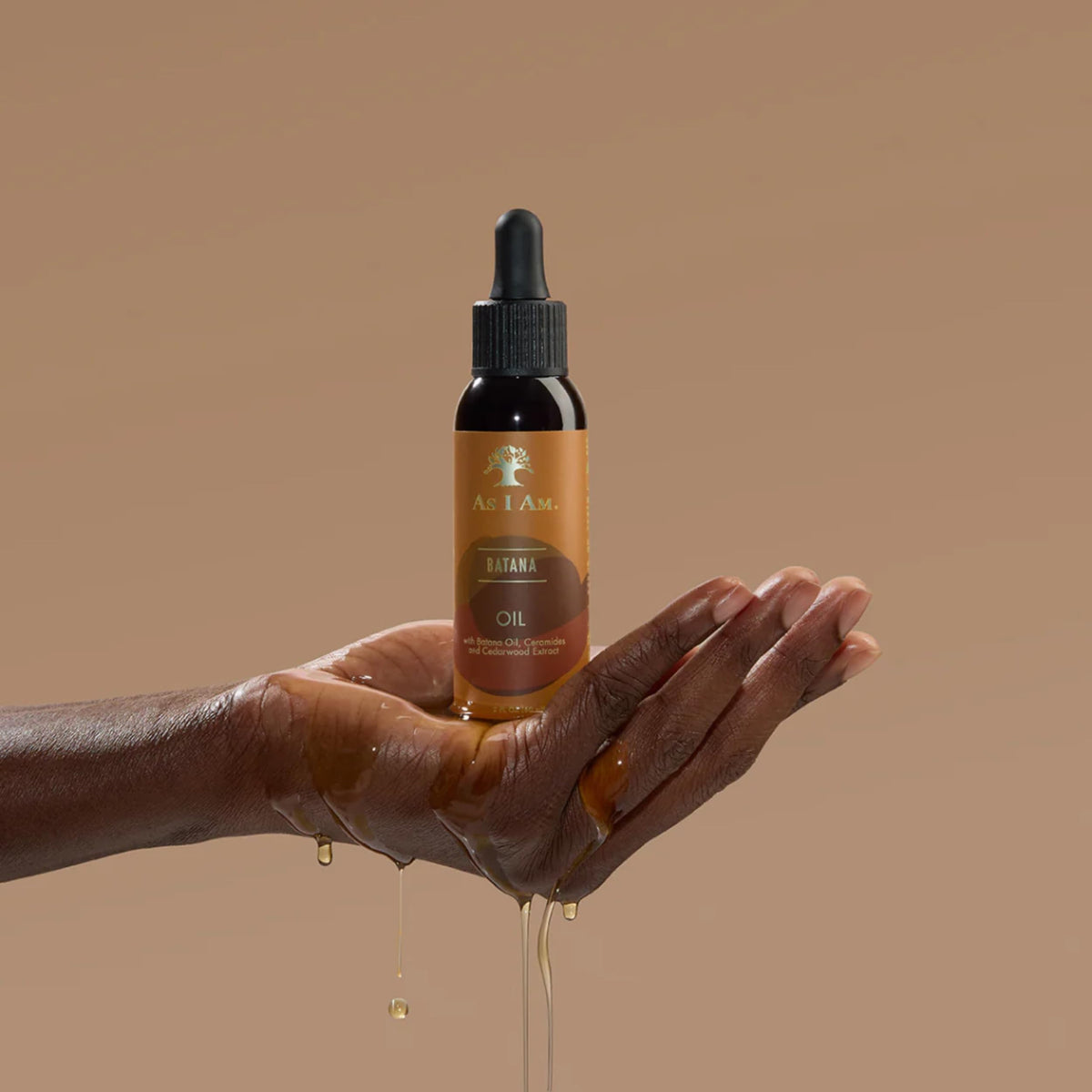 As I Am Batana Oil applied to hands demonstrating easy distribution benefit