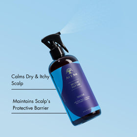Hand spraying As I Am onto scalp to show easy application and targeted relief