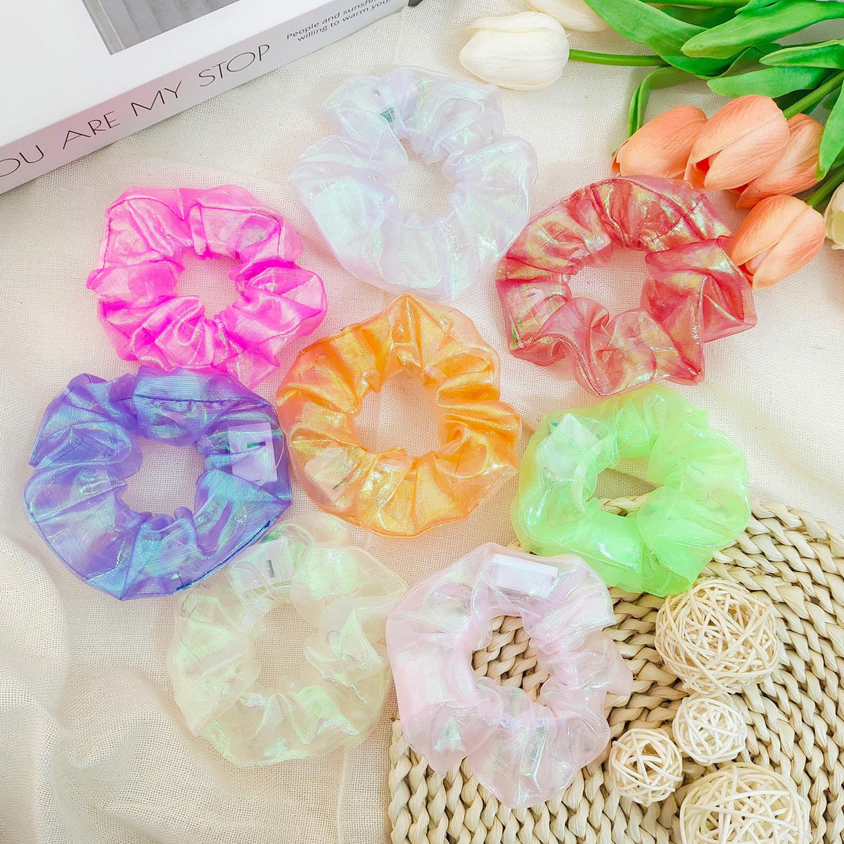 Asawira scrunchie beside a coin for scale showing compact size and easy portability