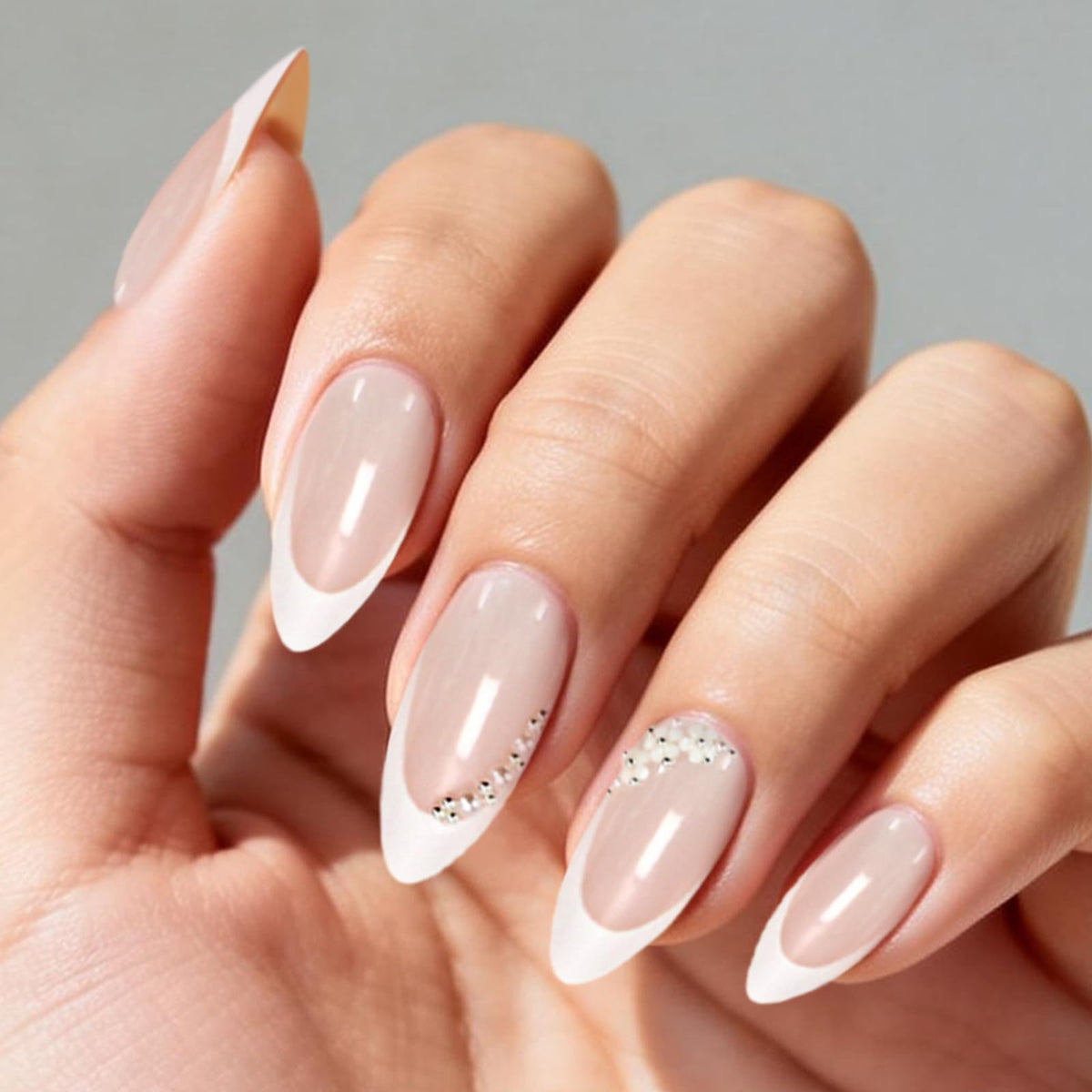 Ashowner applied nails on model hand demonstrating natural look and hold