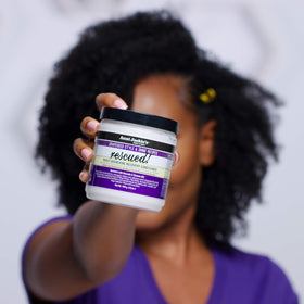 Aunt Jackie's applying conditioner to mid-lengths to seal moisture