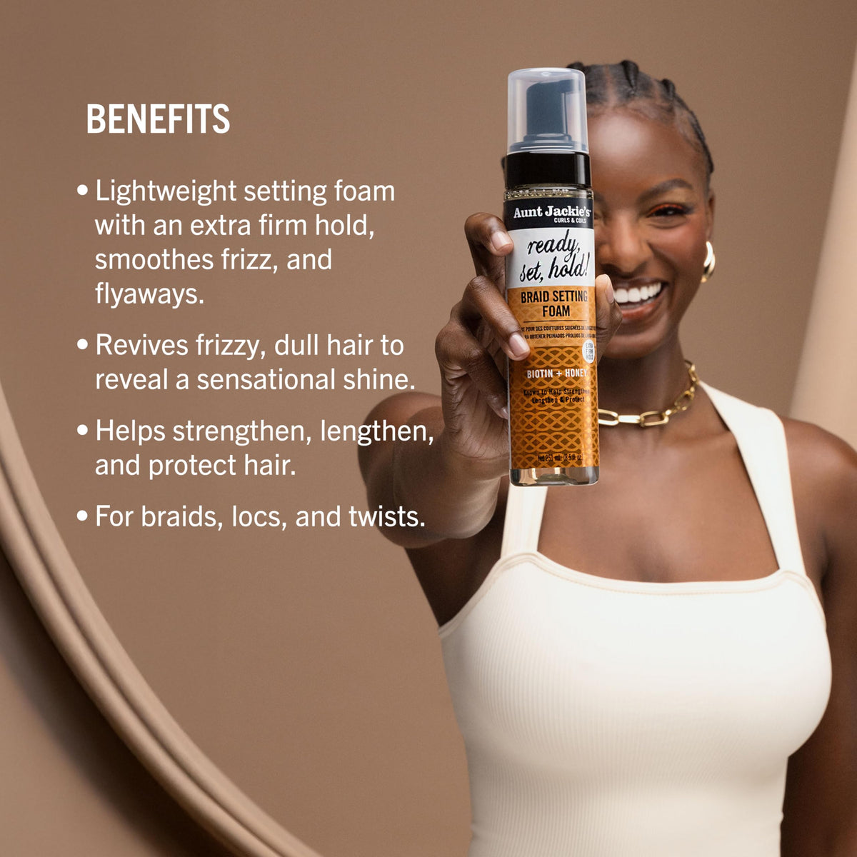 Aunt Jackie's foam being smoothed over a braid to reduce frizz and define