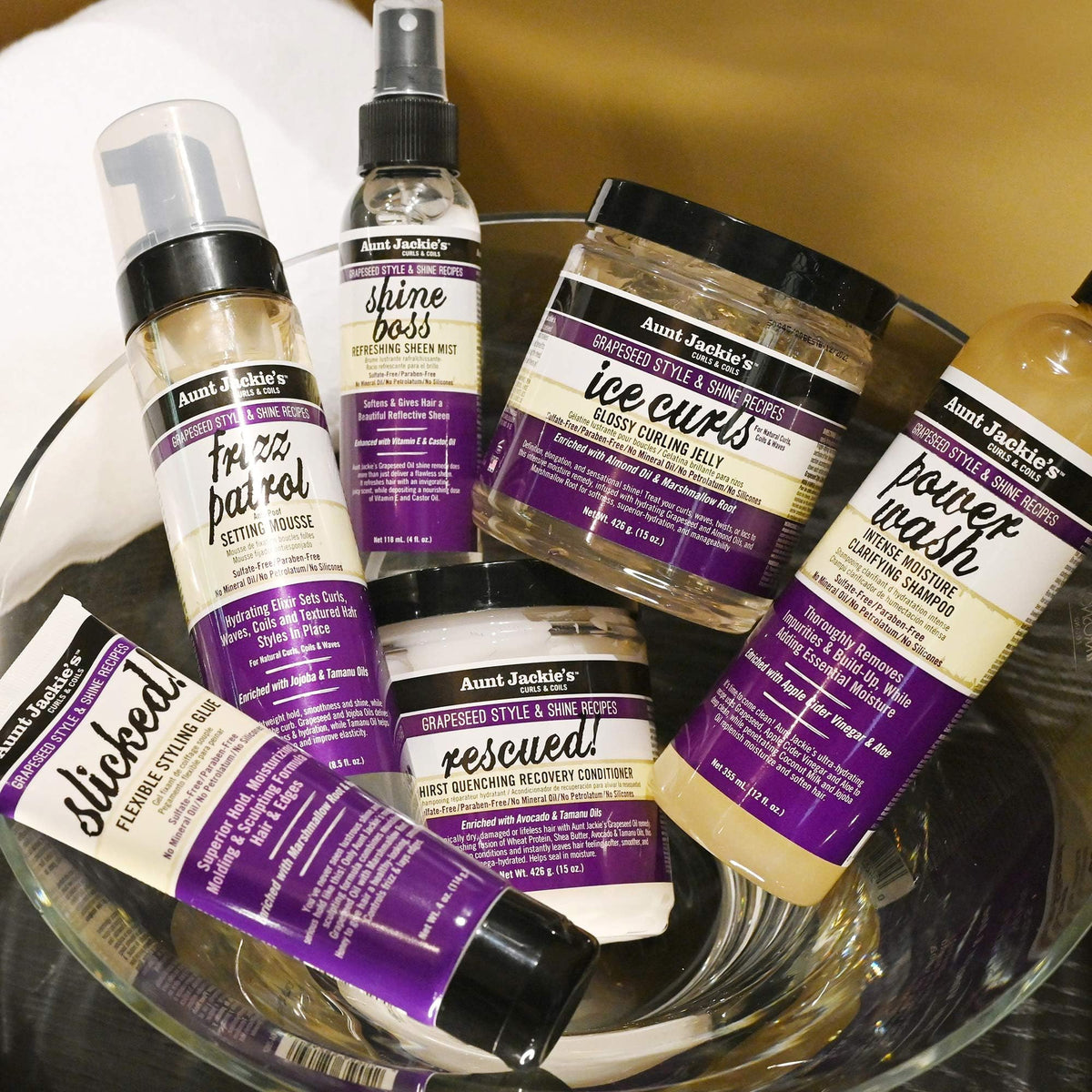 Grapeseed, jojoba, and coconut visuals beside Aunt Jackie's bottle highlighting nourishing oils