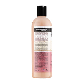 Aunt Jackie's lifestyle model with defined curls outdoors illustrating softer, tangle-free hair