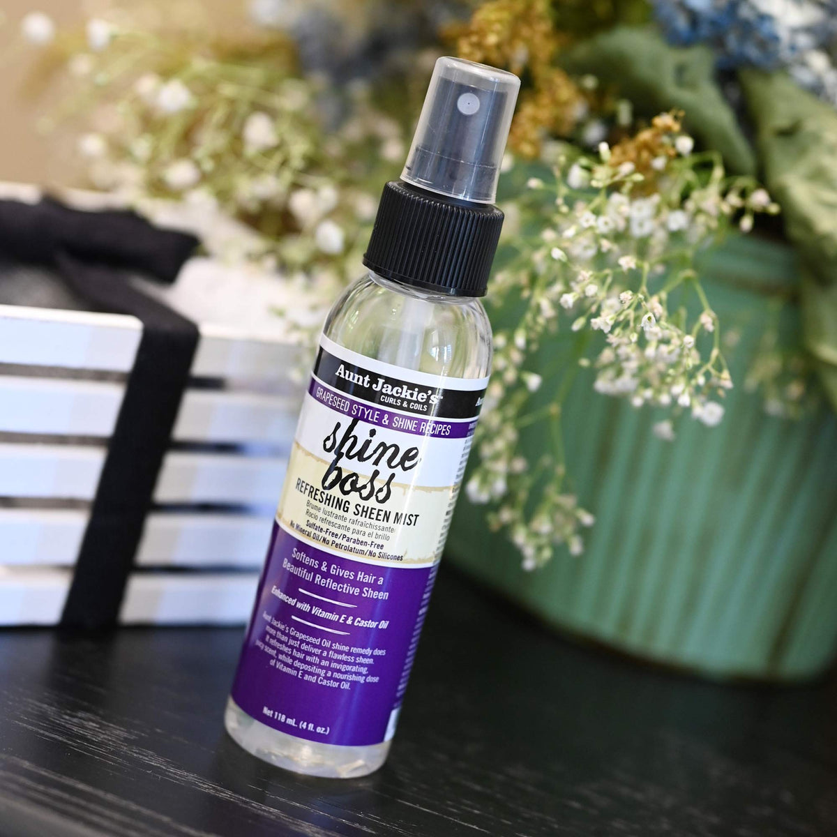 Aunt Jackie's bottle held in a hand showing size and portability for on-the-go use