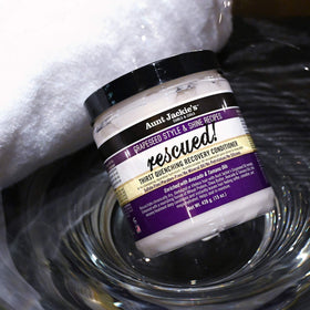Aunt Jackie's 18 oz jar in hand illustrating travel-size practical use