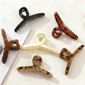Auseibeely clips securing hair under a hat for outdoor comfort