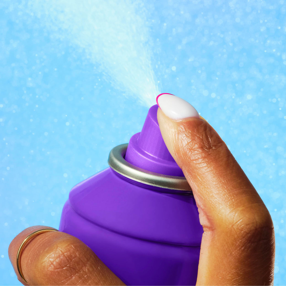 Fine mist from Aussie Instant Freeze spraying onto styled hair for instant set