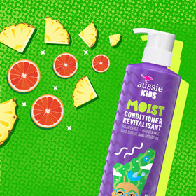 Child applying Aussie conditioner in shower, helps smooth and detangle hair