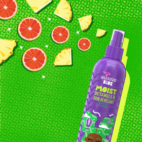 Aussie kids detangler bottle held in hand showing kid-safe size and ease
