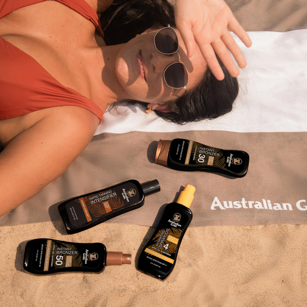 Australian Gold next to a hand for scale showing 8 ounce size and travel convenience