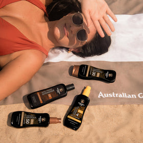 Australian Gold next to a hand for scale showing 8 ounce size and travel convenience