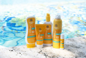Australian Gold applied at beach lifestyle scene for water-resistant confidence