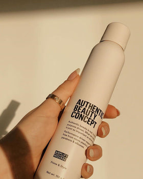 Authentic Beauty Concept product in hand showing 6.7 oz scale and portability