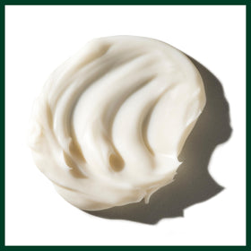 Aveda Beautifying Body Lotion on hand being massaged in to show immediate smoothness and non-greasy finish