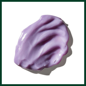 Close-up of Aveda Blue Malva label and ingredient callouts highlights natural-derived benefit