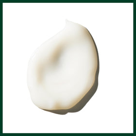 Applying Aveda Cherry Almond to damp hair demonstrating detangling and smoothing benefit