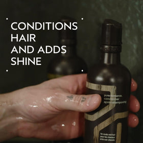 Close-up of Aveda label detail emphasizing natural-derived ingredient transparency