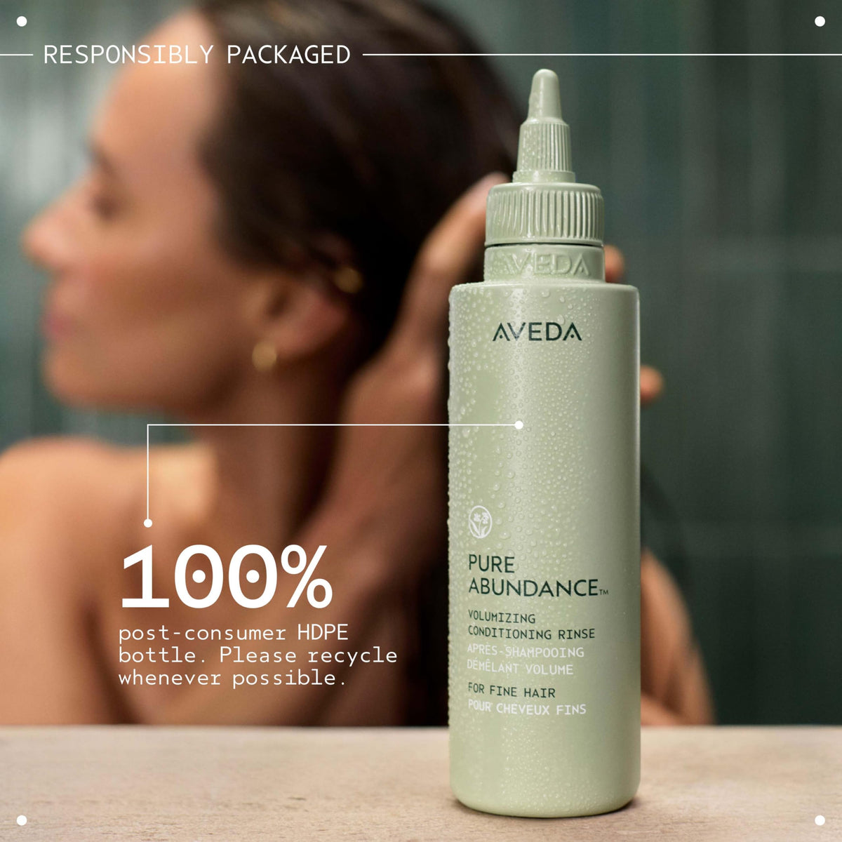 Aveda 5 fl oz bottle next to common items showing compact travel size