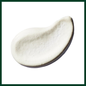 Aveda Radiant Skin Refiner open tube top view showing clay-based cream consistency