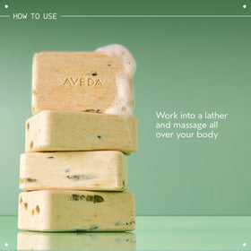 Aveda bar in hand for scale showing compact, travel-friendly benefit
