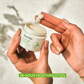 Aveeno applied on hand demonstrating lightweight feel and quick absorption